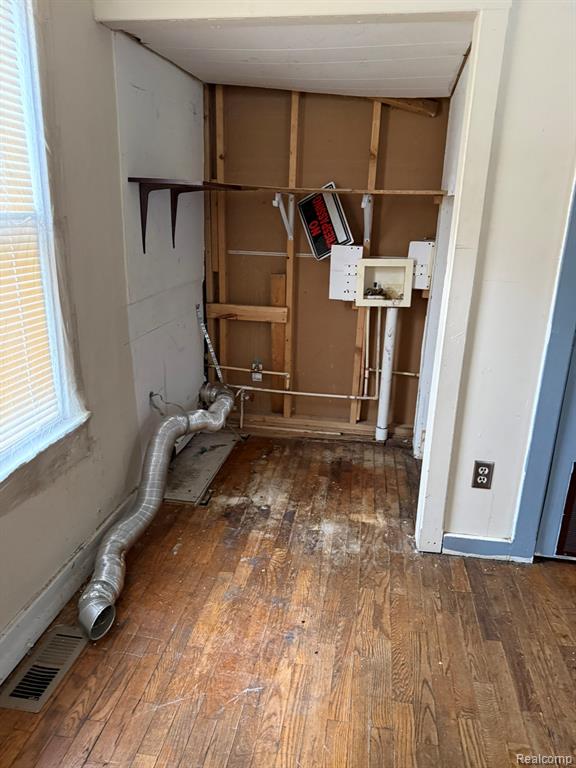 Laundry room with dark wood-type flooring and hookup for a washing machine