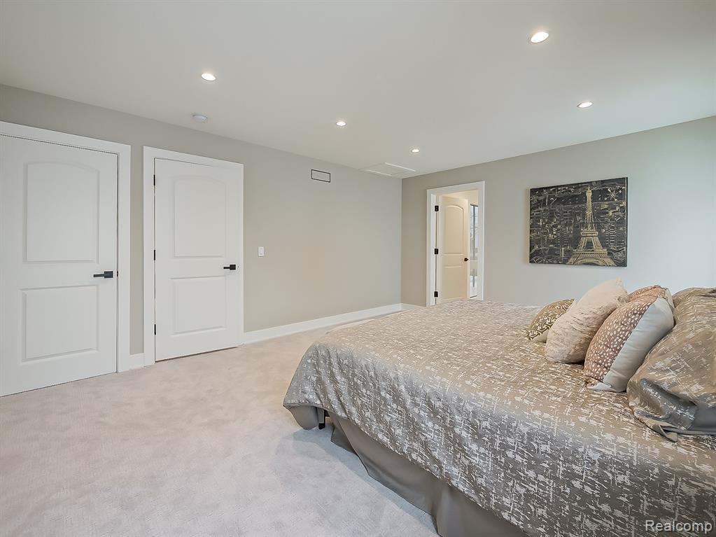 Bedroom with light carpet and recessed lighting