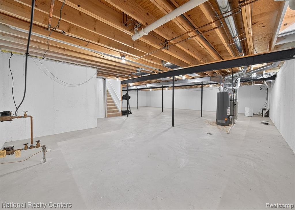 Unfinished below grade area featuring stairway