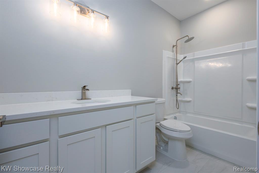 Full Main Bathroom featuring vanity and bathtub / shower combination.