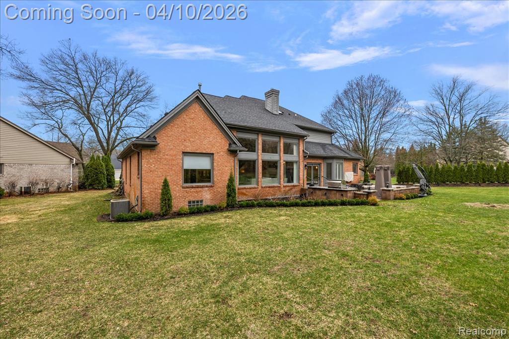 Rear Facade w/Beautiful Landscape, Paver Patio & Outdoor Kitchen