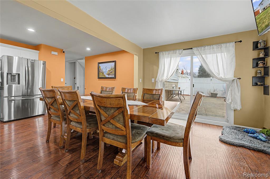 Dining area with dark wood-style flooring and recessed lighting