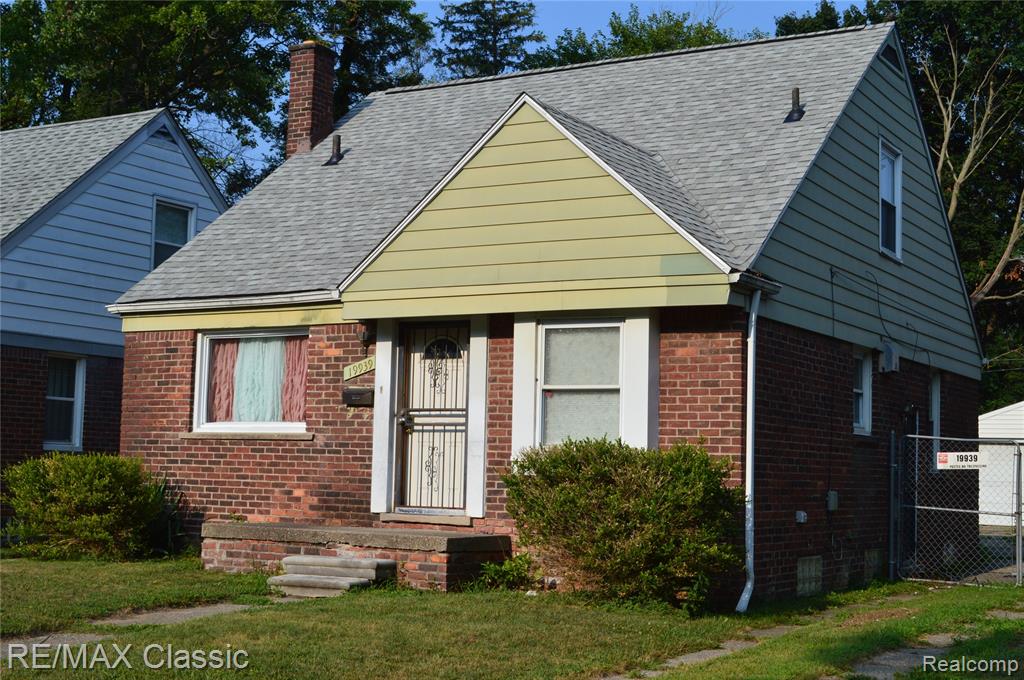 Brick exterior with a gabled roof and light-colored siding