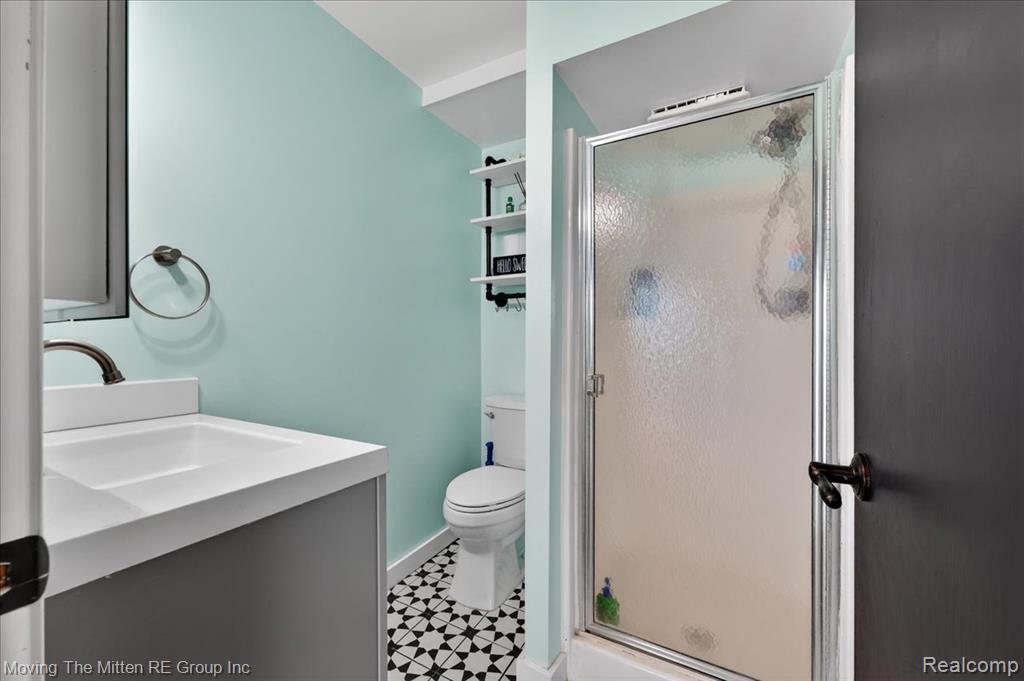 Bathroom with vanity and a shower stall