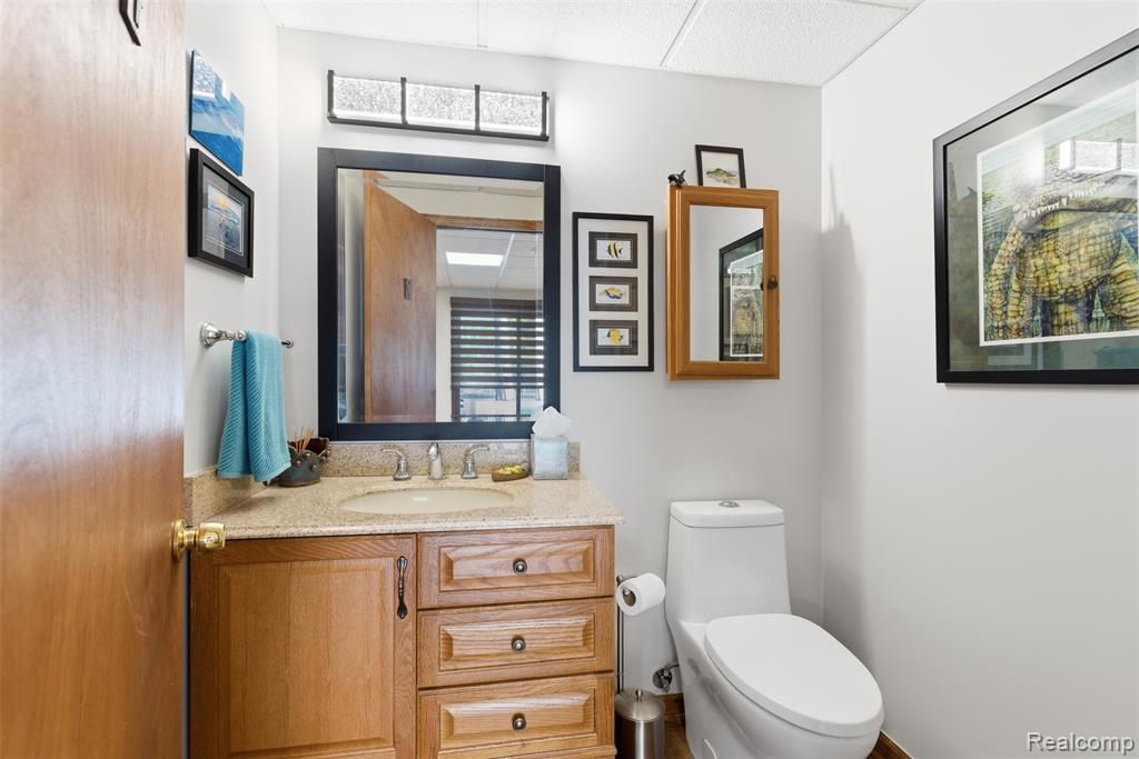 Half bathroom with vanity and toilet