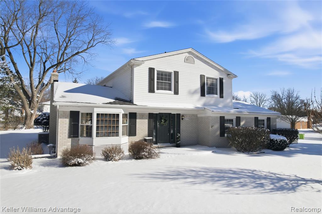 Photo for 22846 Gilbar Street, Novi, MI - listing #20261003143 View of front of house with brick siding and a chimney