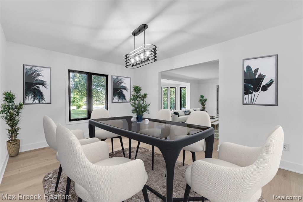 VIRUTALLY STAGED Dining room with light wood finished floors and healthy amount of natural light