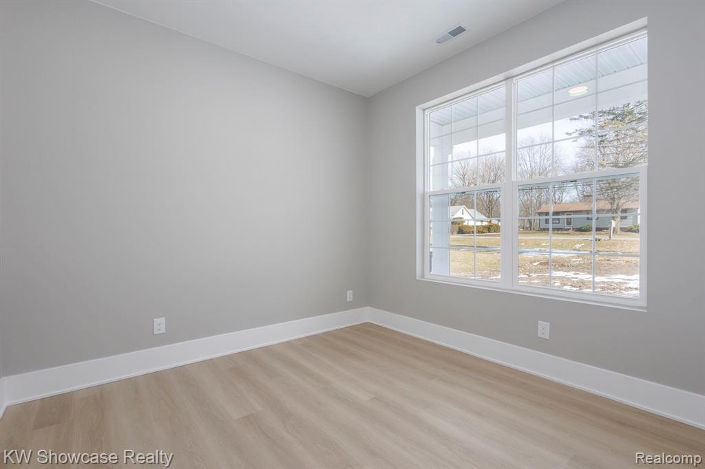 Zero-Entry, No-Steps - Property in mid-construction with brick, concrete driveway, sidewalk, shingled roof, and extra deep garage.