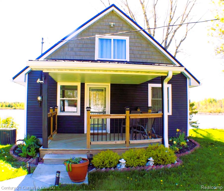Bungalow-style house with covered porch and a front lawn