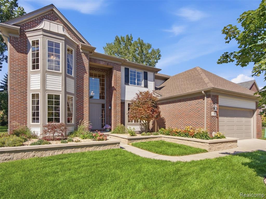 Brick and siding exterior with a prominent two-story bay window