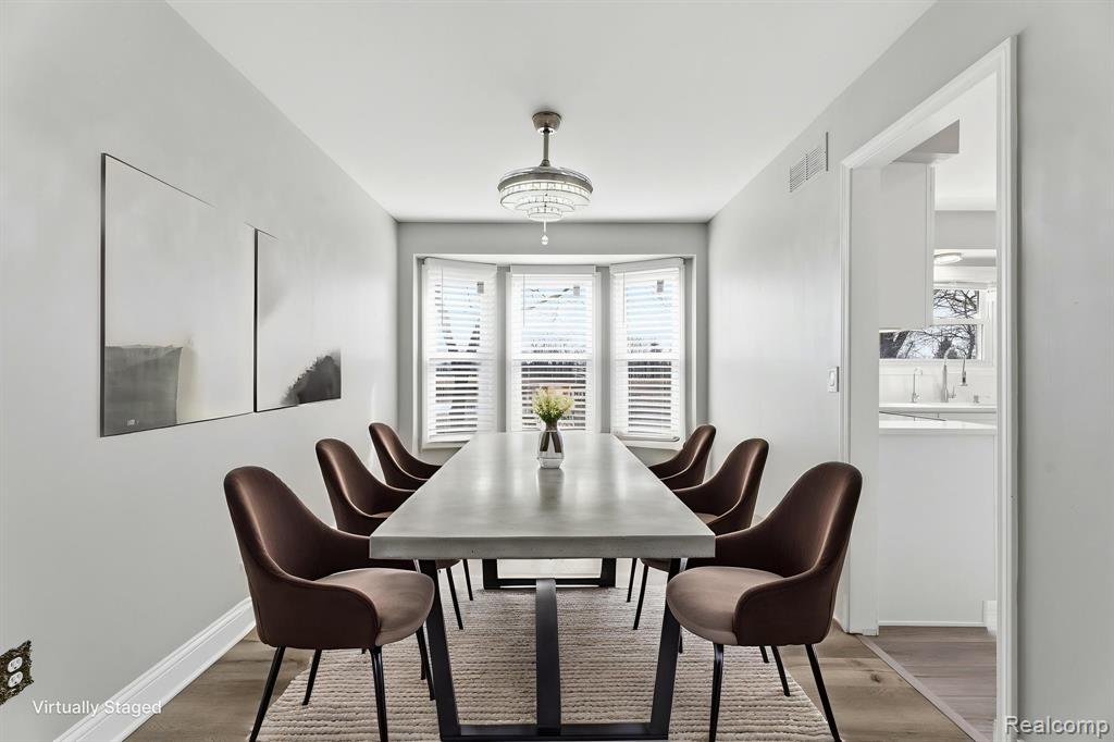 Dining room featuring wood finished floors and baseboards