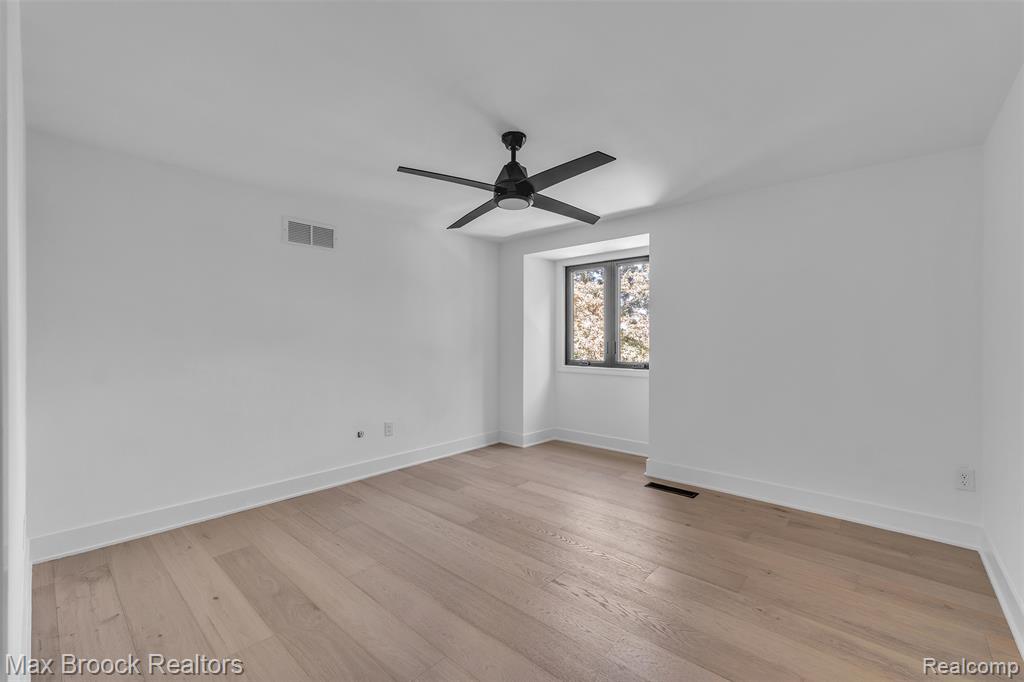 Spare room featuring light wood finished floors and ceiling fan
