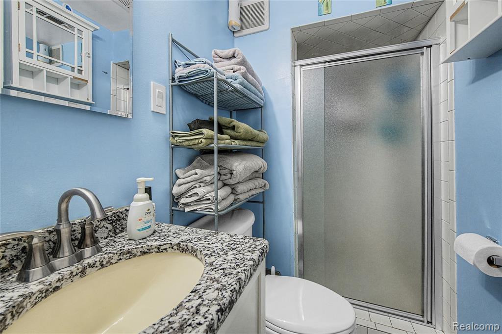 Bathroom with a shower stall and vanity