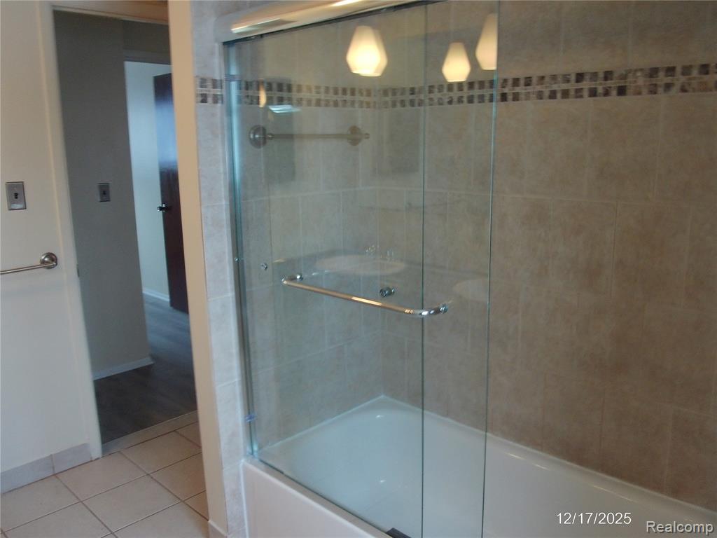 Unfurnished room featuring a paneled ceiling, ceiling fan, and dark wood-style floors