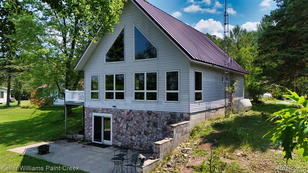 White siding exterior with a dark metal roof