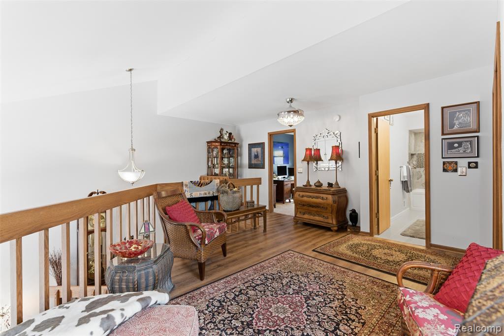 Living room with wood finished floors and lofted ceiling