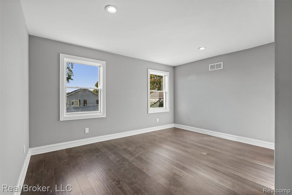 Empty room featuring wood finished floors and recessed lighting