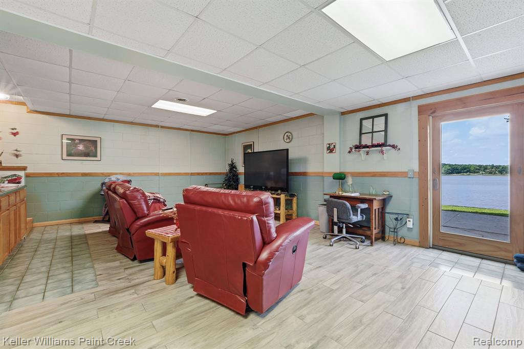 Wood-finish flooring throughout, with a wood-paneled and painted wall design