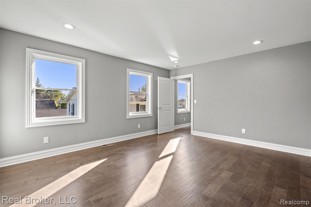Unfurnished room featuring recessed lighting and dark wood-type flooring