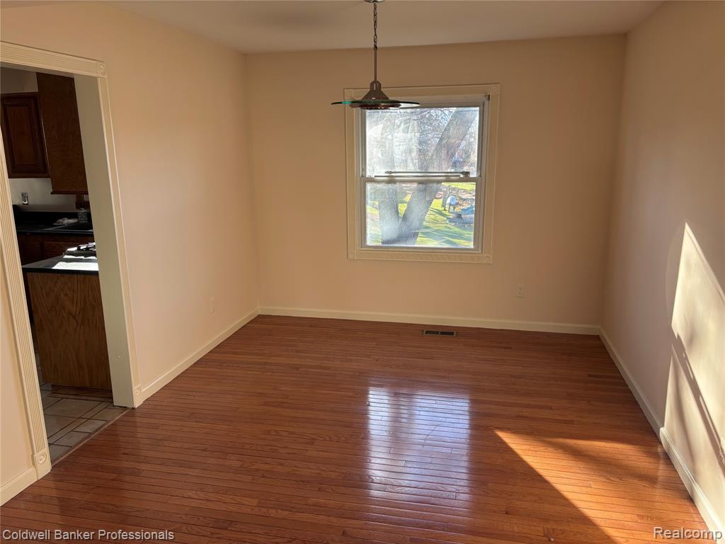 Formal Dining area featuring dark wood-style floors and baseboards