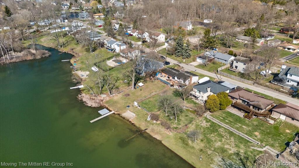 Aerial overview of property's location featuring a large body of water and nearby suburban area