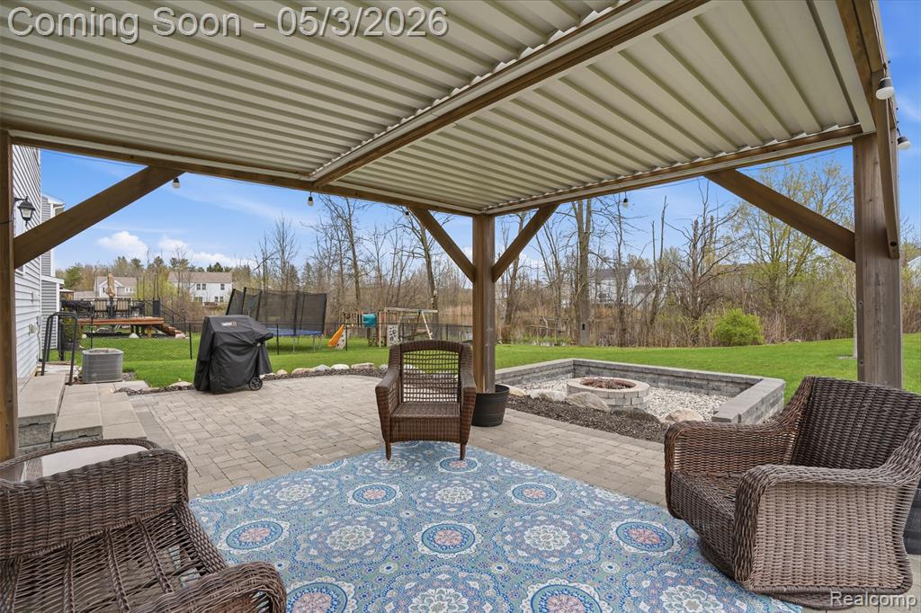 View of patio featuring an outdoor fire pit, and area for grilling