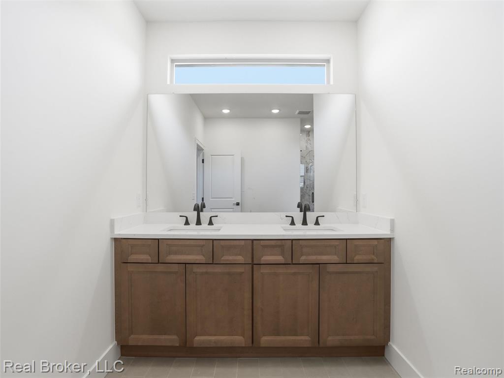 Bathroom featuring double vanity and recessed lighting