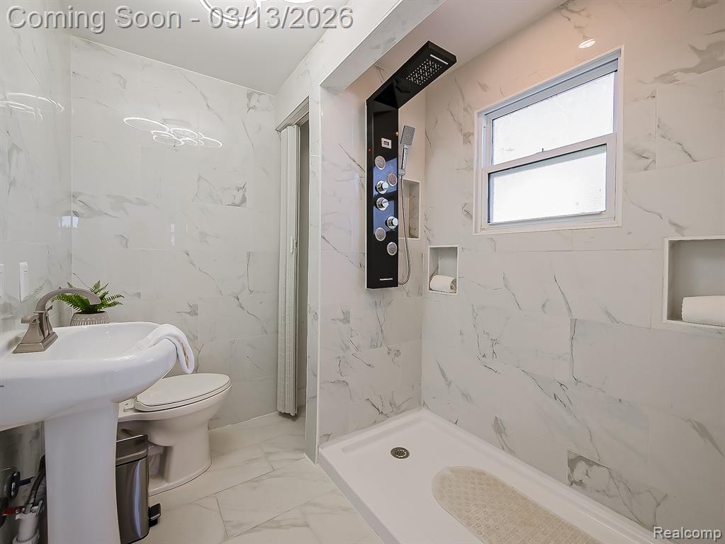 Bedroom featuring light marble finish floors and ceiling fan