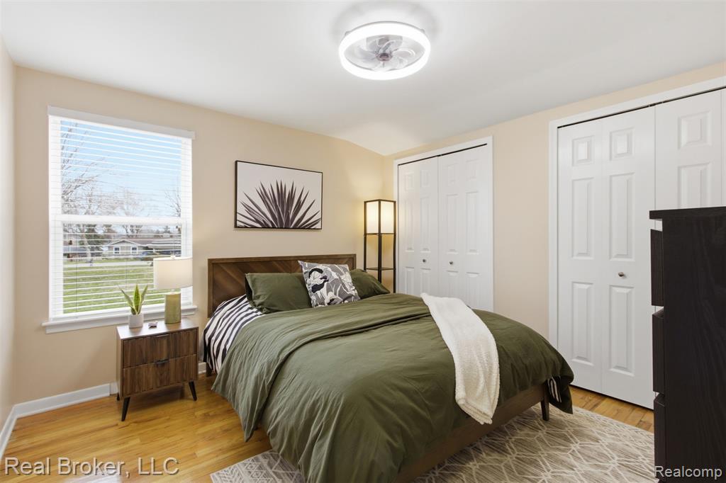 Bedroom with two closets and light wood finished floors