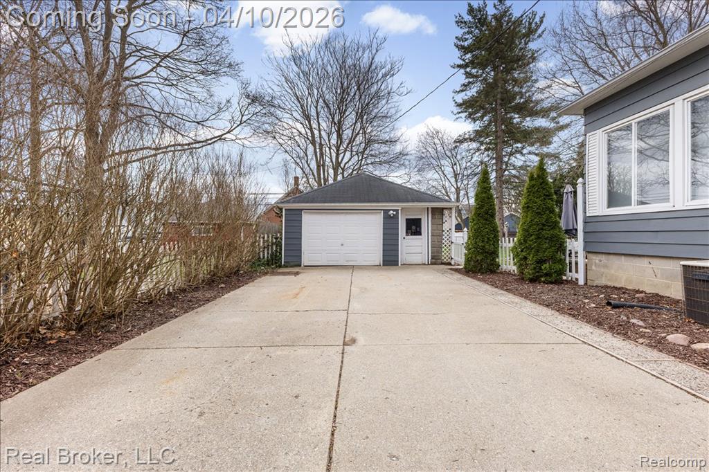 Detached garage with concrete driveway