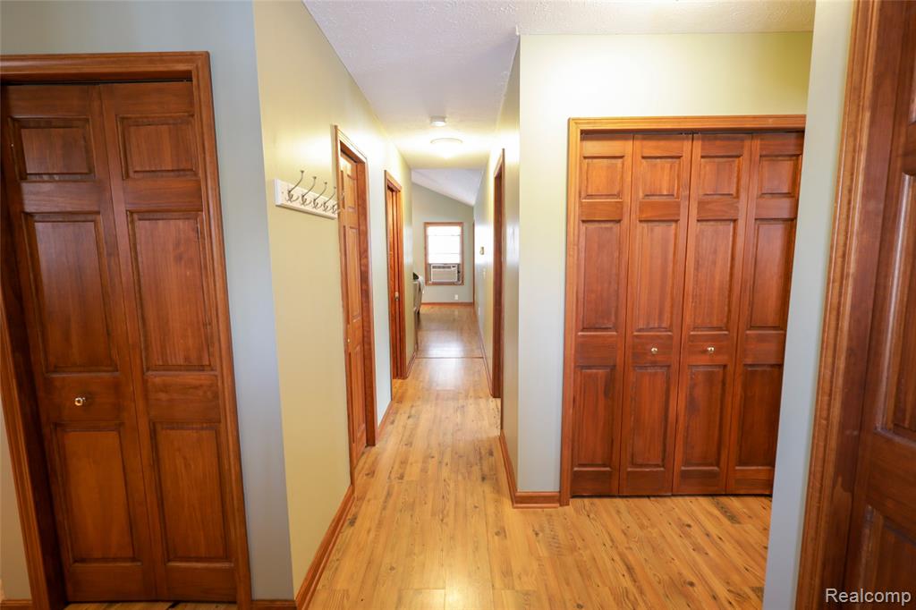 Hall with light wood-type flooring and baseboards