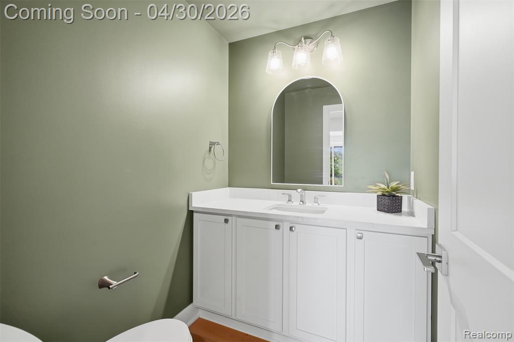 Powder Room with vanity and light wood-style flooring