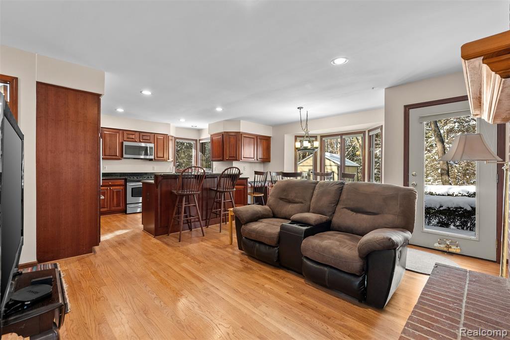 Living area with recessed lighting and light wood finished floors
