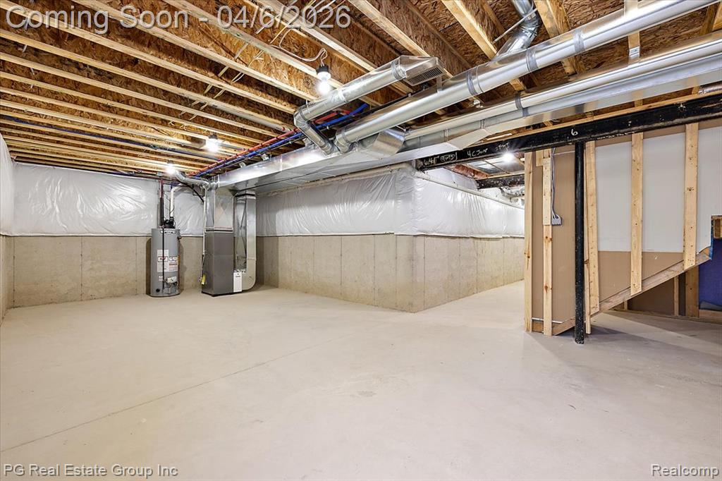 Unfinished basement with heating unit and water heater