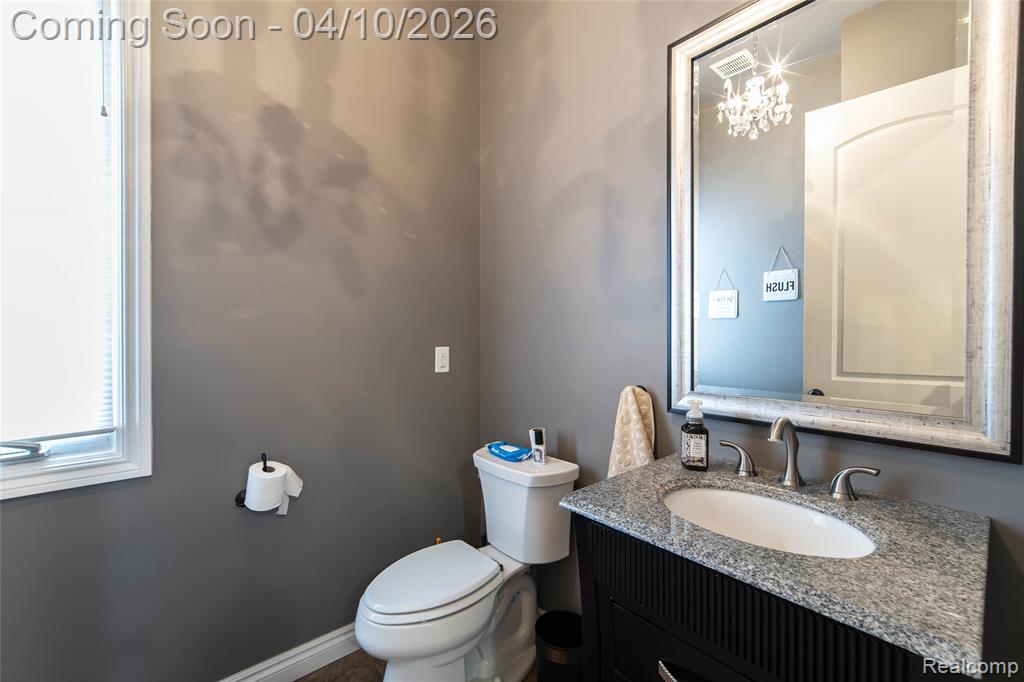 Half bathroom with toilet and vanity