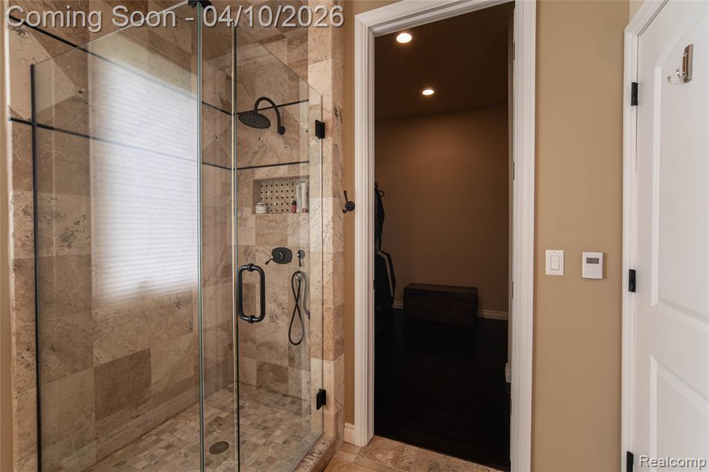Full bathroom with recessed lighting and a stall shower