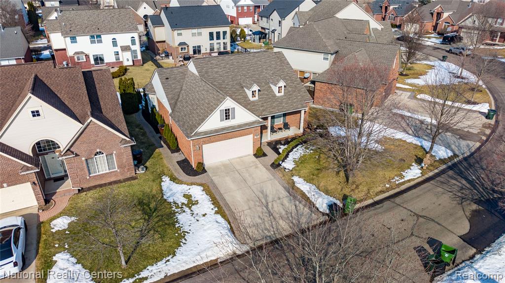 Snowy aerial view featuring a residential view