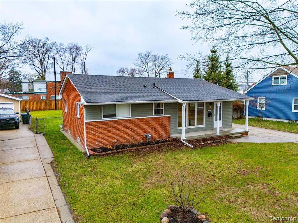Bungalow-style house with brick siding, a porch, a chimney, and roof with shingles