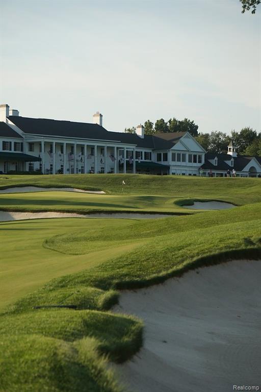 Surrounding community featuring golf course view and a gate