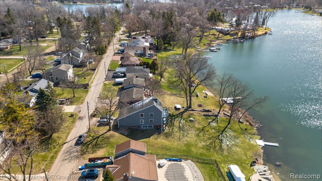 Aerial perspective of suburban area with a large body of water