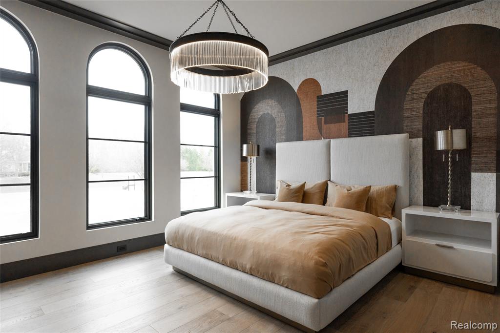 Bedroom with hardwood / wood-style floors, crown molding, and wallpapered walls