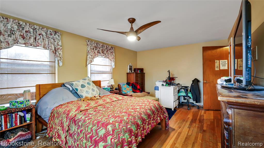 Bedroom with hardwood / wood-style flooring and a ceiling fan