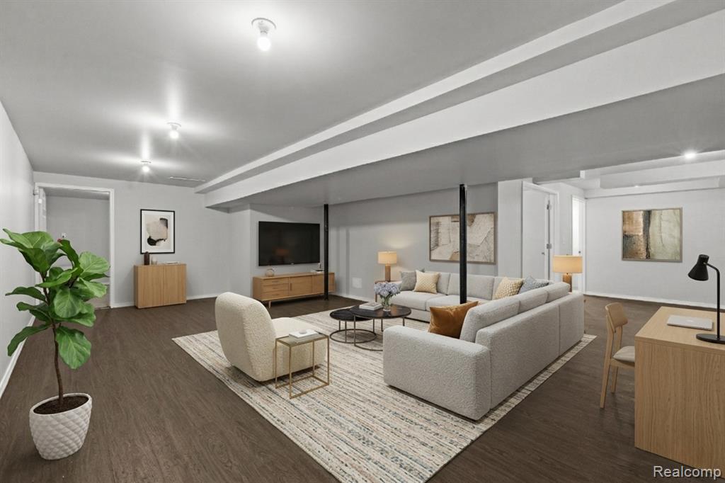Kitchen featuring dark countertops, decorative light fixtures, blue cabinets, a kitchen island, and stainless steel appliances