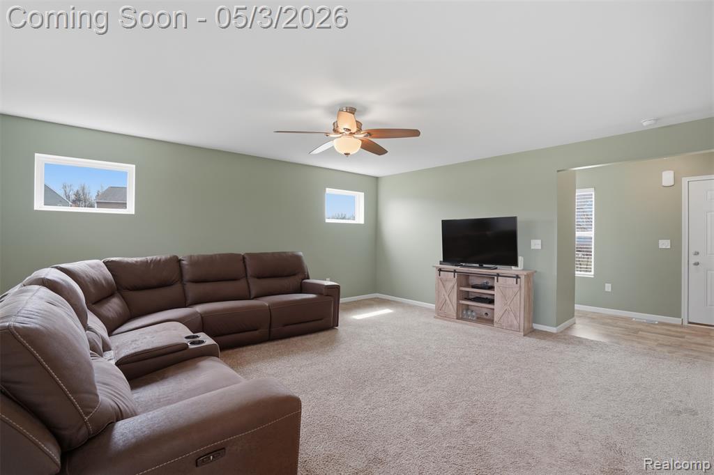 Living room with a ceiling fan and carpet floors