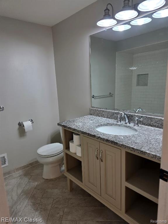 Full bath featuring vanity and a shower