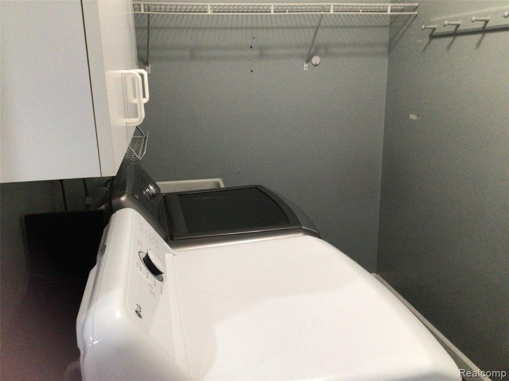 Laundry room featuring washer / dryer and water heater