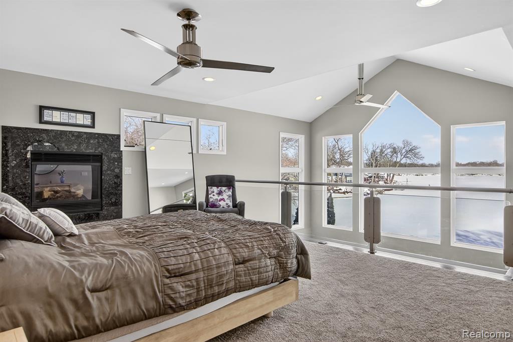 Office space with light colored carpet and recessed lighting
