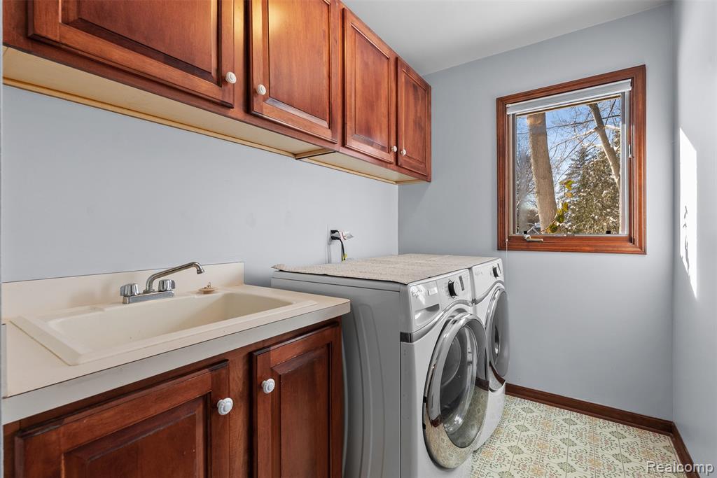 Laundry area with cabinet space and separate washer and dryer