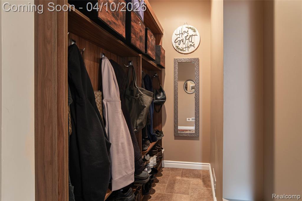 Mudroom featuring baseboards and stone finish floors