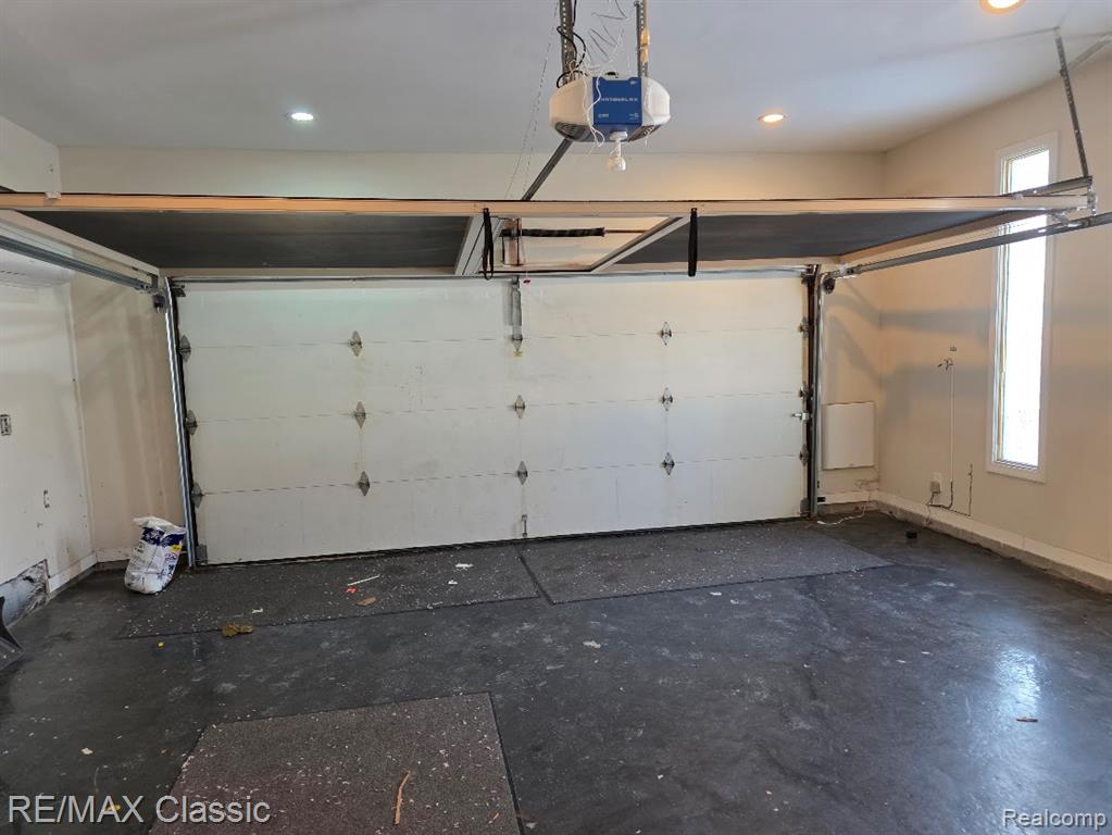 Garage with recessed lighting and a garage door opener